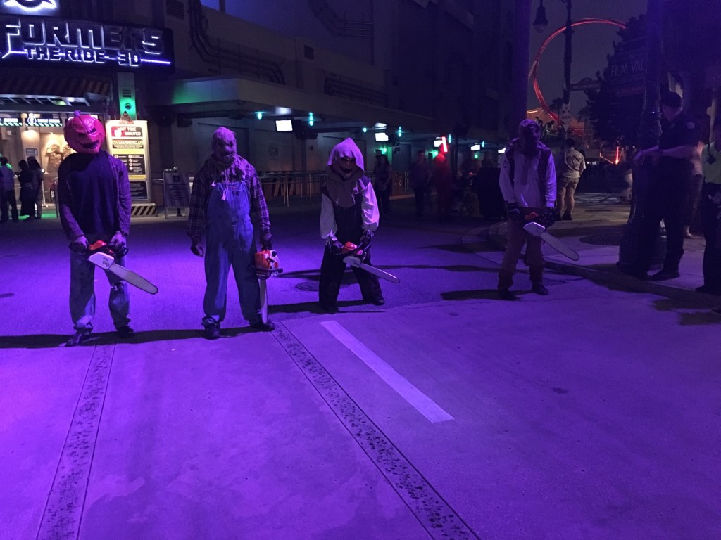 Figures holding chainsaws